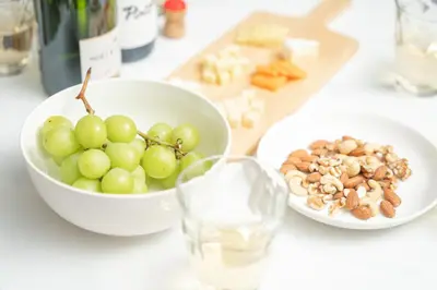 a white bowl of grapes and nuts on a table at Midtown OIMACHI Hub in Tokyo