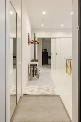 a kitchen with white walls and a table in a room at residence MINAMI-AOYAMA102 in Tokyo