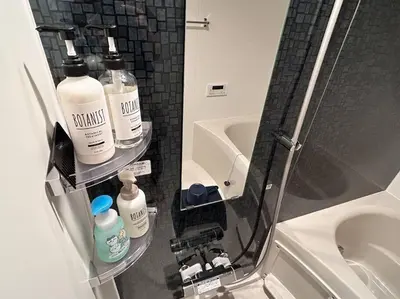 a bathroom with three bottles of toiletries on a shelf at residence MINAMI-AOYAMA102 in Tokyo