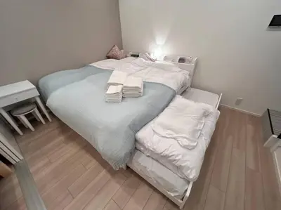 a bedroom with a large bed with two towels on it at residence MINAMI-AOYAMA102 in Tokyo