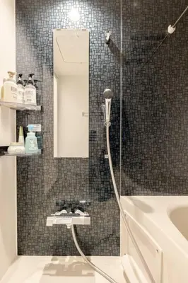 a bathroom with a shower with a sink and a mirror at residence MINAMI-AOYAMA102 in Tokyo
