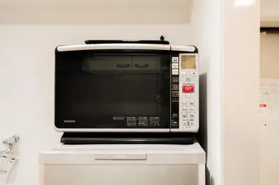 a microwave oven sitting on top of a cabinet at Kamata Opus2 Apartment in Tokyo