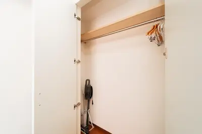 a sliding door in a closet with a phone at Kamata Opus2 Apartment in Tokyo