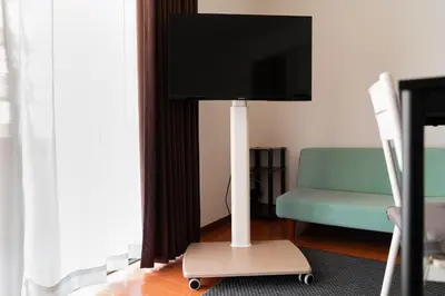 a flat screen tv on a stand in a living room at Kamata Opus2 Apartment in Tokyo