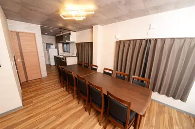 a conference room with a long wooden table and chairs at ACTResidence\u7b2c\u4e8c 4\u5ba41\u30d0\u30b9\u30eb\u30fc\u30e01\u30b7\u30e3\u30ef\u30fc3\u30c8\u30a4\u30ec in Tokyo