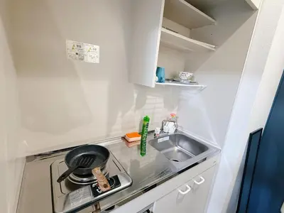 a small kitchen with a sink and a stove at Tokyo Shinjuku Waseda House\u65b0\u5bbf\u65e9\u7a32\u7530 in Tokyo