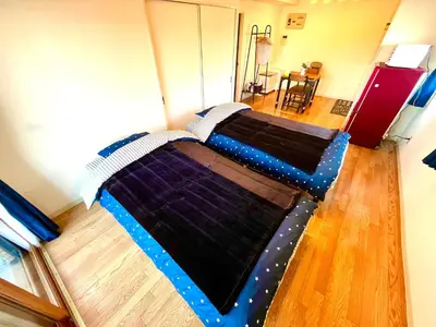 a large bed in a living room with at Nr Ikebukuro! Room size 45m2! Free unlimited Wi-Fi! in Tokyo