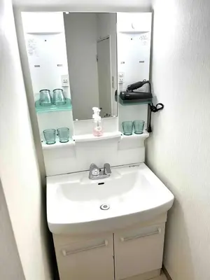 a bathroom with a white sink and a mirror at Nr Ikebukuro! Room size 45m2! Free unlimited Wi-Fi! in Tokyo