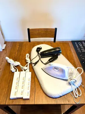 a desk with a cell phone and a remote control at Nr Ikebukuro! Room size 45m2! Free unlimited Wi-Fi! in Tokyo