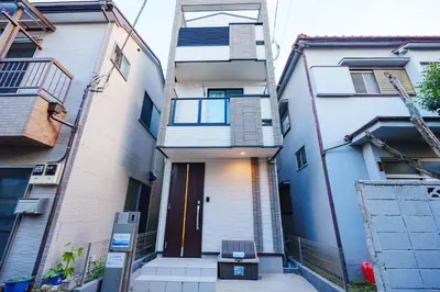 an apartment building with a door in the middle of a street at GH5286 Eight minutes to Akihabara Complete facilities and convenient location in Tokyo