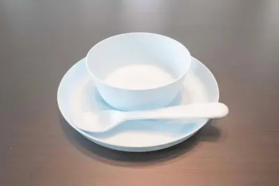 a white coffee cup and spoon on a plate at \u30a2\u30f3\u30c9\u30b9\u30c6\u30a4\u304a\u82b1\u8336\u5c4b1\u4e01\u76ee301 in Tokyo
