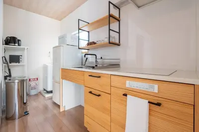 a kitchen with a wooden counter and a refrigerator at \u30a2\u30f3\u30c9\u30b9\u30c6\u30a4\u5927\u68ee\u897f2\u4e01\u76ee in Tokyo