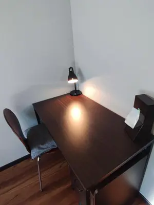 a wooden desk with a lamp and a chair at \u30e9\u30d1\u30f3\u30a2\u30b8\u30eb in Tokyo