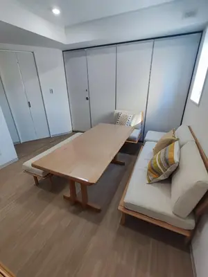 a living room with a wooden table and a couch at \u30e9\u30d1\u30f3\u30a2\u30b8\u30eb in Tokyo