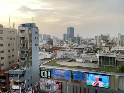 a view of a city with a tv on a building at Shinjuku house 2 in Tokyo