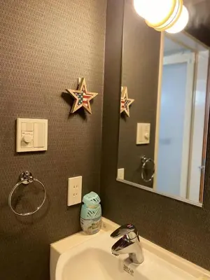 a bathroom with a sink and a mirror and stars on the wall at Shinjuku house 2 in Tokyo