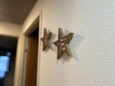 two wooden stars on the side of a wall at Shinjuku house 2 in Tokyo