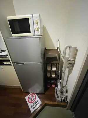 a microwave sitting on top of a refrigerator at ToyamaHouse2-202 in Tokyo
