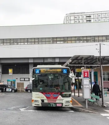 a bus is parked at a bus stop at ToyamaHouse2-202 in Tokyo