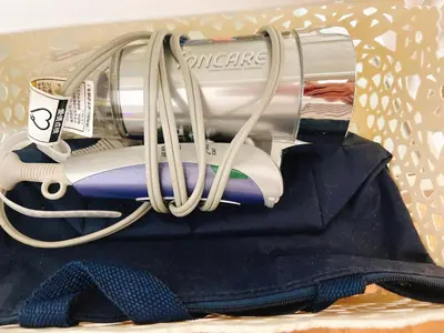 a box with a hair dryer and a bundle of clothes at ToyamaHouse2-202 in Tokyo