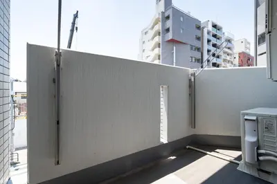 a privacy fence on a balcony of a building at GRAN PASEo\u9ad8\u5186\u5bfa\u5357 in Tokyo