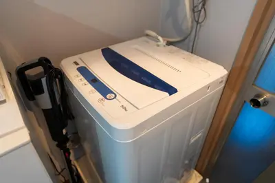a white and blue device sitting on top of a refrigerator at Tokyo Yamate line Takadanobaba station one room partment in Tokyo