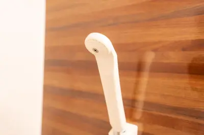 a white toothbrush holder sitting on a wooden floor at Tokyo Yamate line Takadanobaba station one room partment in Tokyo