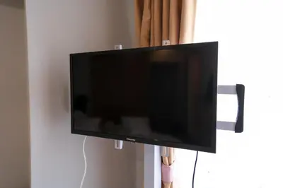 a flat screen tv hanging on a wall at Tokyo Yamate line Takadanobaba station one room partment in Tokyo