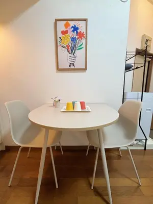 a white table and chairs with a plate on it at Mori house ookubobiru in Tokyo