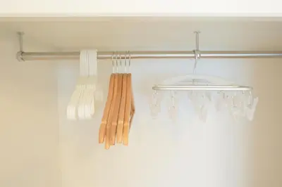 a towel rack with three woodenaments hanging from it at Sunny Court by Tranova in Tokyo