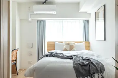 a bedroom with a large bed with a window at Dash Living Asakusa East in Tokyo