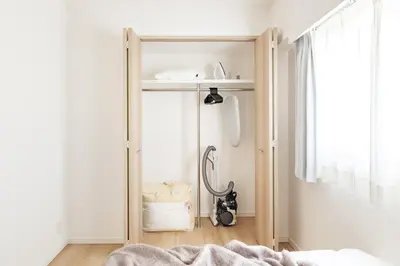 a bedroom with a closet with a bed and a window at Dash Living Asakusa East in Tokyo