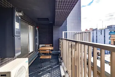 a balcony with chairs and tables on a building at Dash Living Asakusa East in Tokyo