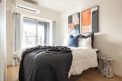 a bedroom with a bed and a window at Dash Living Asakusa East in Tokyo