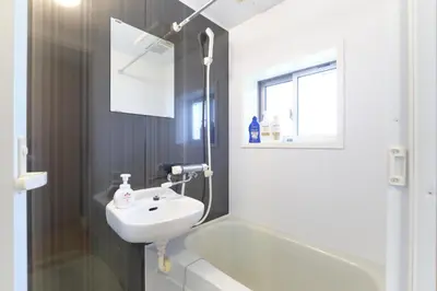 a white bathroom with a sink and a bath tub at Domire Setagaya by Tranova in Tokyo