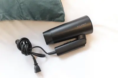 a black hairdryer with a cord on a table at Domire Setagaya by Tranova in Tokyo