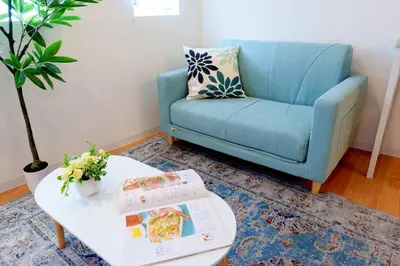 a blue couch and a coffee table in a living room at Higashi-Shinjuku 904 in Tokyo