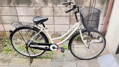 a bike with a basket parked against a wall at Push house Urayasu - Vacation STAY 18038 in Tokyo