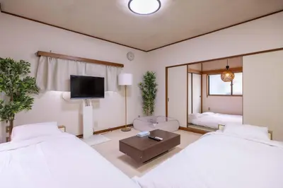 a hotel room with two beds and a mirror at 2F - Vacation STAY 51571v in Tokyo