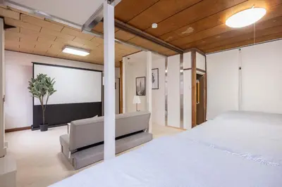 a bedroom with a large bed and a projection screen at 2F - Vacation STAY 51571v in Tokyo