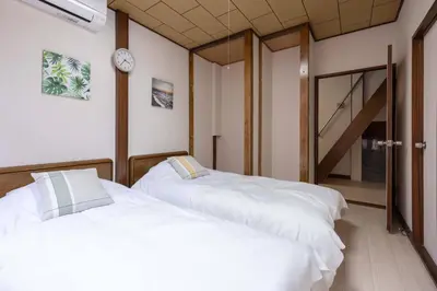 two white beds in a room with a staircase at 2F - Vacation STAY 51571v in Tokyo