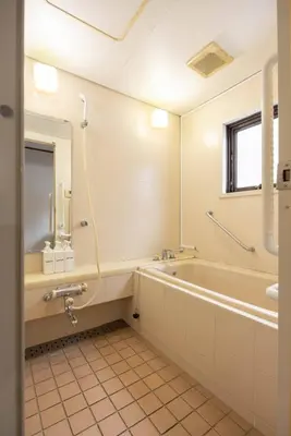 a bathroom with a tub and a sink and a mirror at 2F - Vacation STAY 51571v in Tokyo