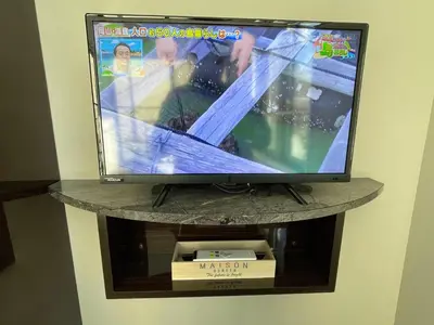 a television sitting on a shelf in a room at COMMA HOUSE Shinjuku 303 in Tokyo