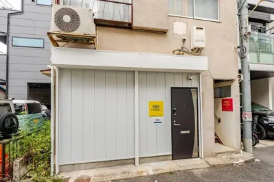 a building with a fan on the side of it at \u30a2\u30f3\u30c9\u30b9\u30c6\u30a4\u6e0b\u8c37\u672c\u753a5\u4e01\u76ee1f in Tokyo