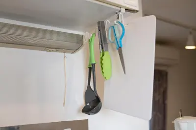 a kitchen with utensils hanging from a wall at Royal Palace in Tokyo