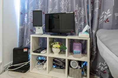 a tv on a white shelf with a computer on it at Royal Palace in Tokyo