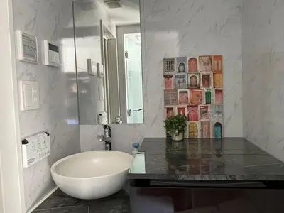 a bathroom with a sink and a large mirror at COMMA HOUSE Shinjuku 401 in Tokyo