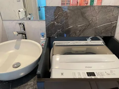 a bathroom with a toilet and a sink at COMMA HOUSE Shinjuku 401 in Tokyo