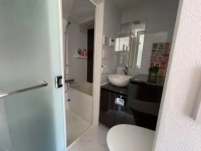 a white bathroom with a sink and a toilet at COMMA HOUSE Shinjuku 401 in Tokyo