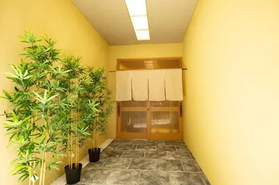 a hallway with two potted plants in a room at \u30a2\u30f3\u30c9\u30b9\u30c6\u30a4\u6d45\u83495\u4e01\u76ee1f in Tokyo